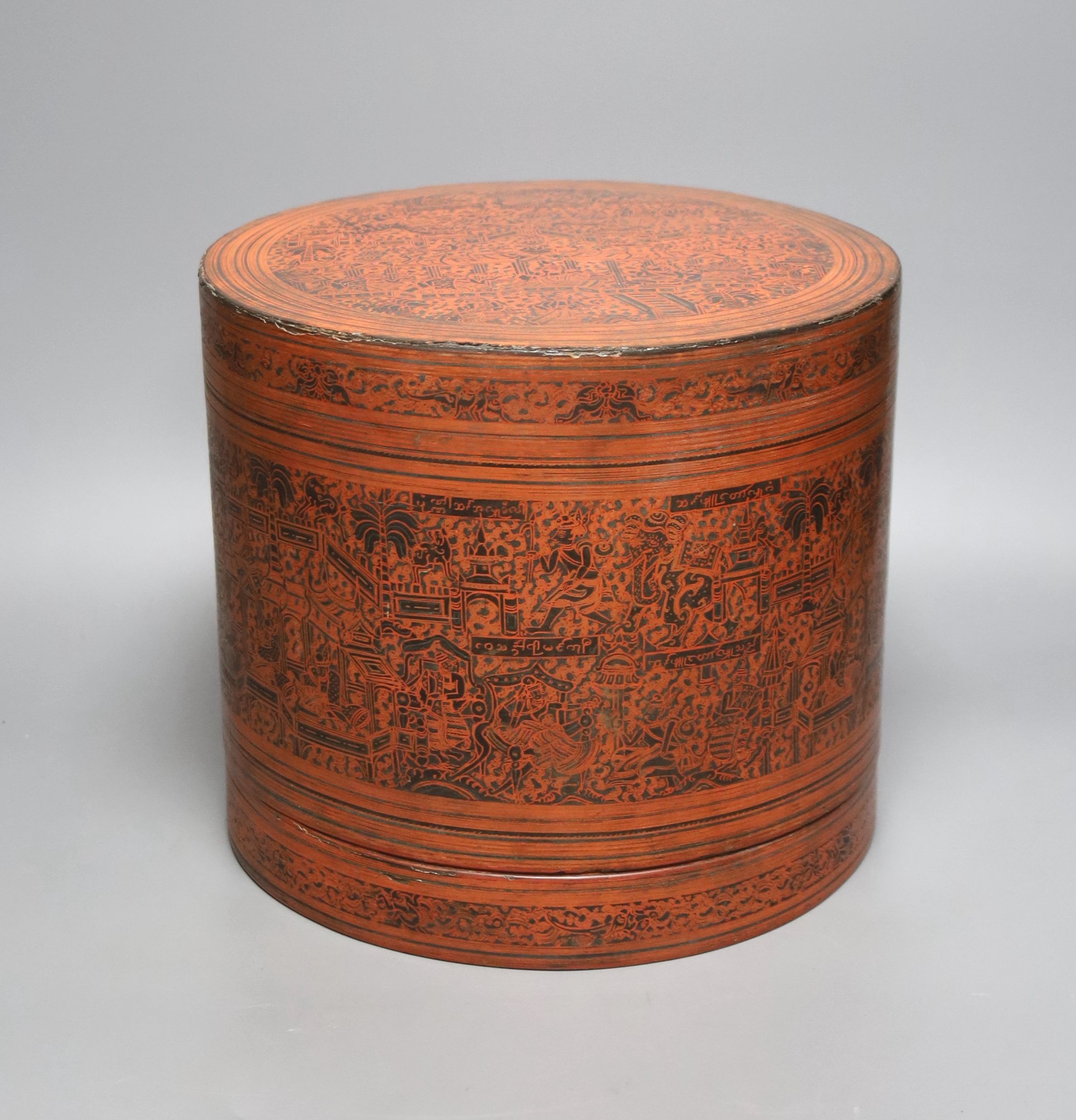A large Burmese red and black lacquer betel box and cover with internal tray, late 19th century, 22cm